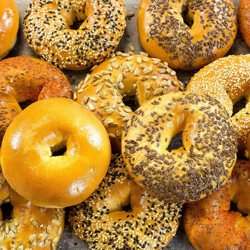Assortment of La Bella Bean bagels, including plain, sesame, poppy seed, sunflower seed, and everything varieties.